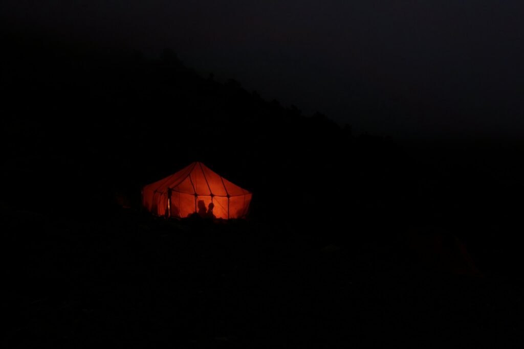 a lighted up tent in the dark